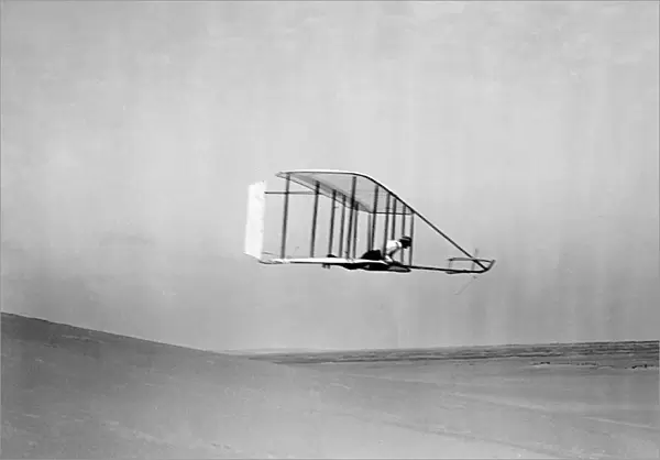 Wilbur Wright flying their glider, near the bottom of Big Hill, Kitty Hawk, North Carolina. Photographed by Orville Wright, 10 October 1902