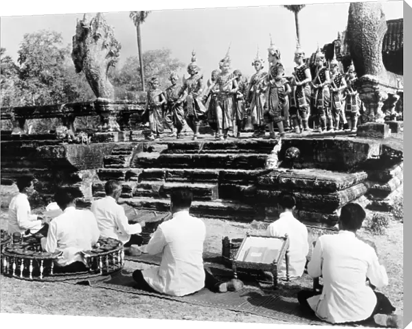 Traditional dancers and musicians performing at the ruins at Angkor, Cambodia. Photographed c1960