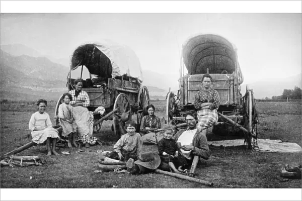COLORADO: EMIGRANTS. A group of emigrants posing at their wagons near the foothills
