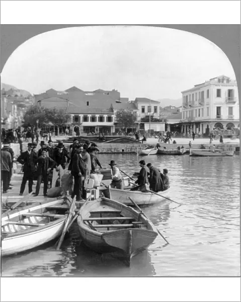 GREEK IMMIGRANTS, c1910. Greek immigrants embarking in rowboats for a steamship