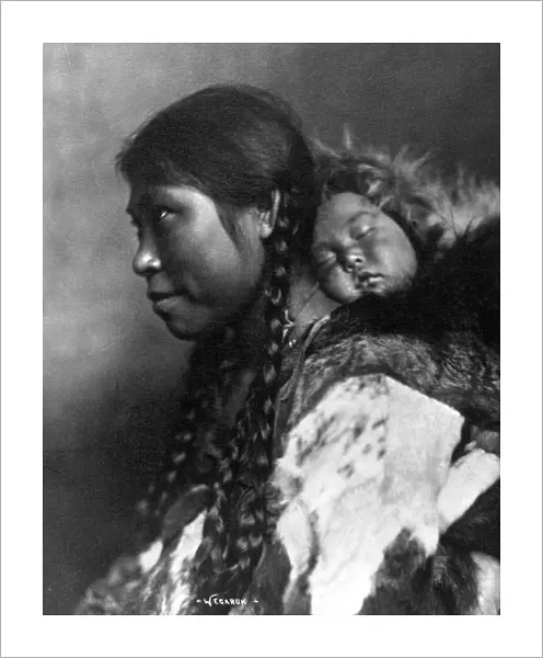 ALASKA: ESKIMOS, c1905. A mother carrying her sleeping child on her back, Nome, Alaska