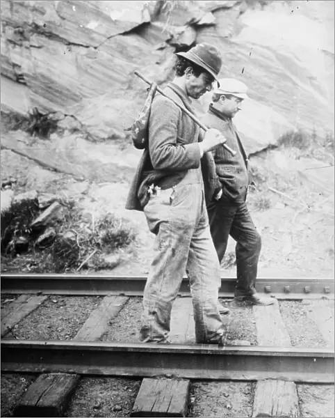 HOBOS, c1920. Hobos walking along the railroad tracks, after being kicked off the train