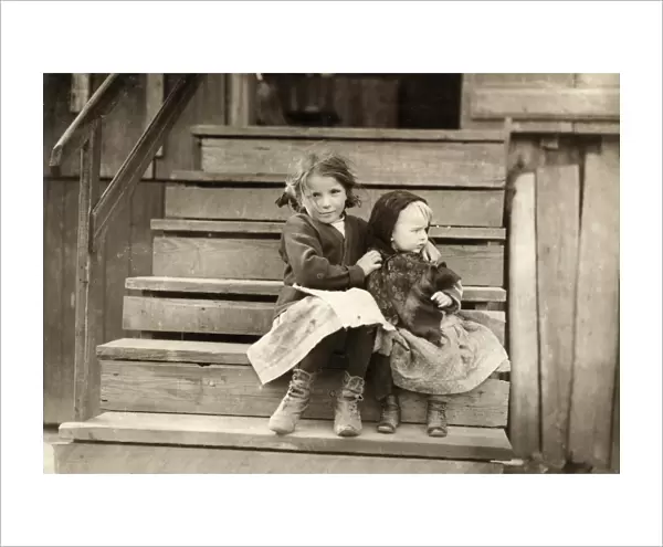 HINE: SISTERS, 1911. A young girl taking care of her baby sister while her family