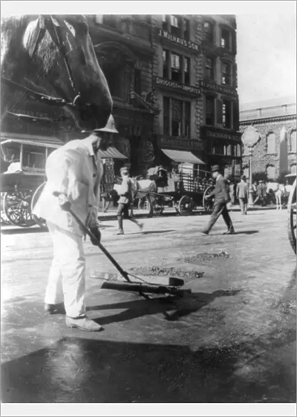 STREET SWEEPER, c1910. A street sweeper, employed by the Department of Sanitation