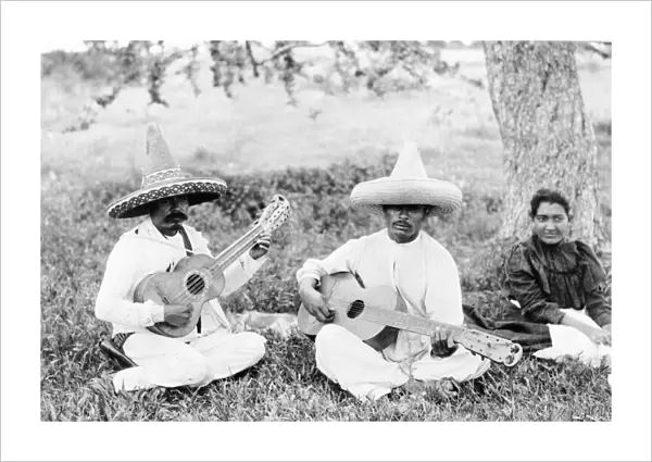MEXICO: GUITAR PLAYERS. Two men playing guitars while seated on the grass next