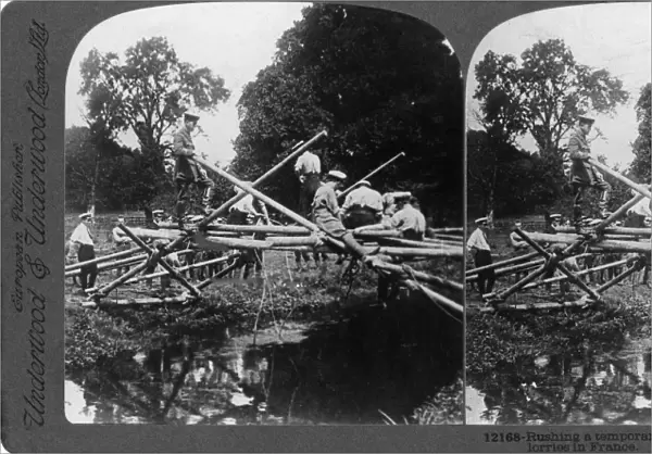 WORLD WAR I: BRIDGE. Troops building a temporary bridge for the transport of motor