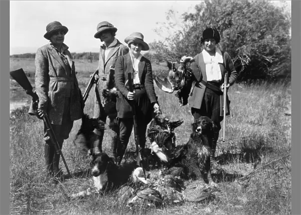 HUNTING, c1919. Women hunters posing with their dogs and dead birds in Idaho