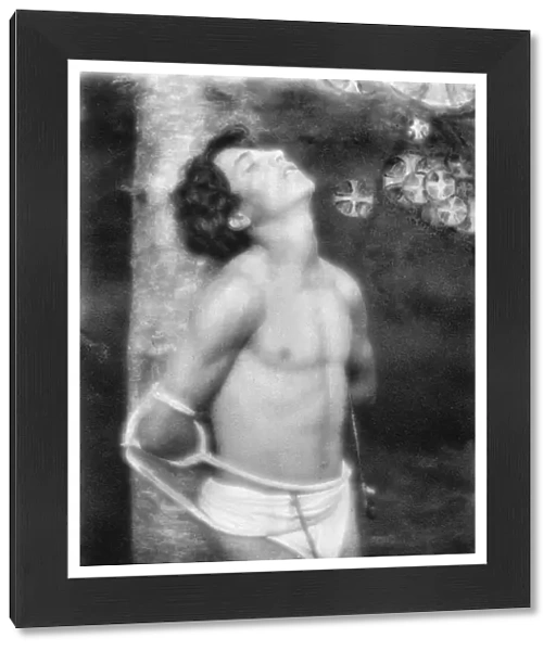 DAY: SAINT SEBASTIAN, c1906. Saint Sebastian tied to a tree with arrows in his stomach and side