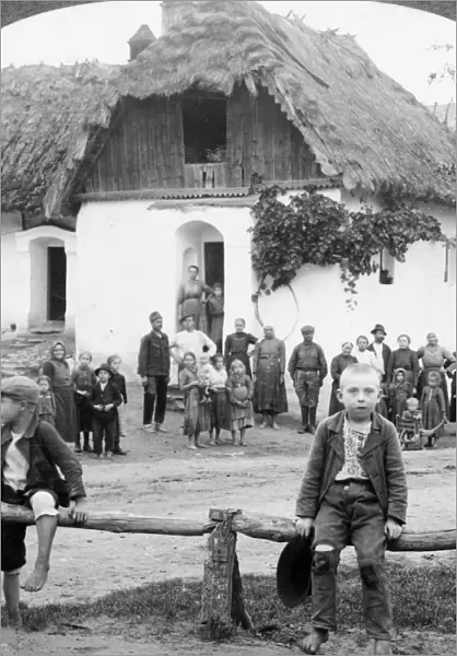 CZECH VILLAGE, c1893. Two boys sitting on a rail fence in front of a building with
