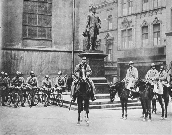 RHINELAND OCCUPATION, 1923. A French general with cavalry patrol beside the statue