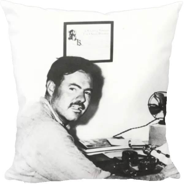 ERNEST HEMINGWAY (1899-1961). American writer. At the typewriter in 1929 in Key West