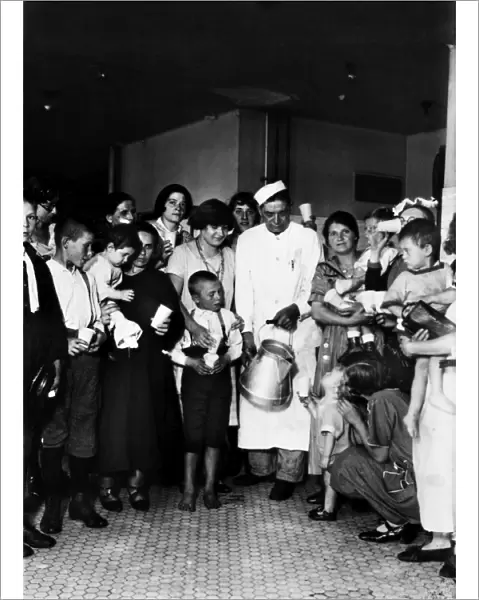 ELLIS ISLAND: MILKMAN, 1925. Distribution of milk among immigrant women and children