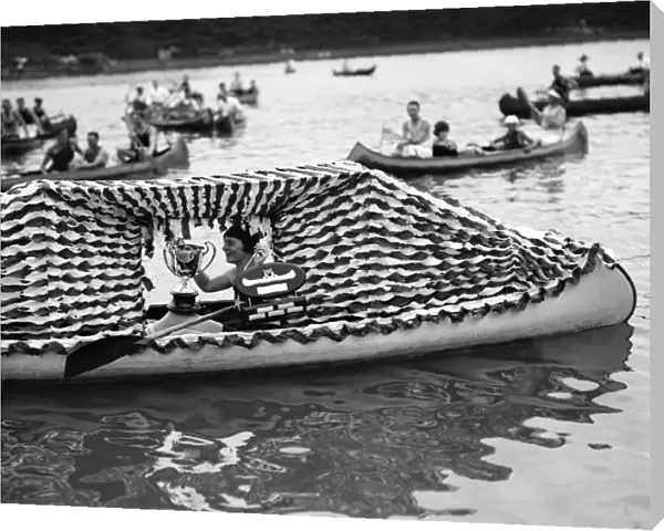 CANOE REGATTA, 1924. A woman holding a trophy at the Canoe Regatta and Water Carnival