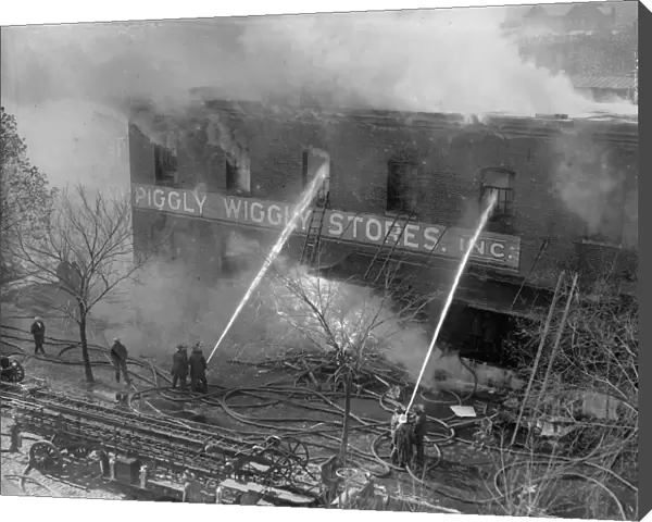 PIGGLY WIGGLY FIRE, 1923. Firefighters battling a fire at a Piggly-Wiggly self-service