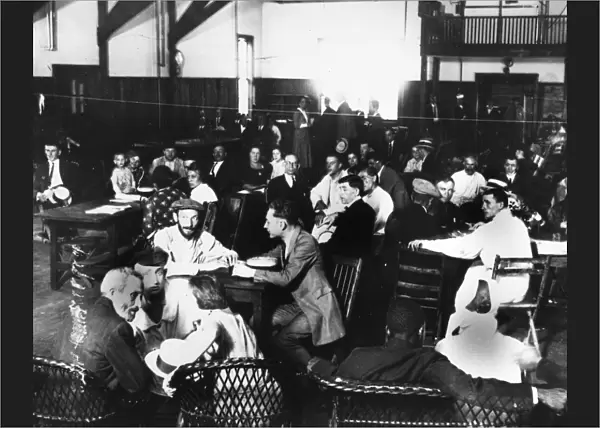 ELLIS ISLAND, 1923. Immigrants in the dining hall at Ellis Island. Photograph, 1923