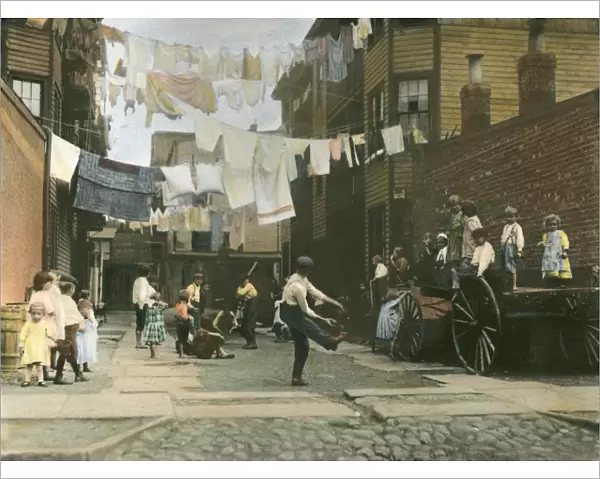 LOWER EAST SIDE, c1910. Children using a tenement alley for a playground in New York City