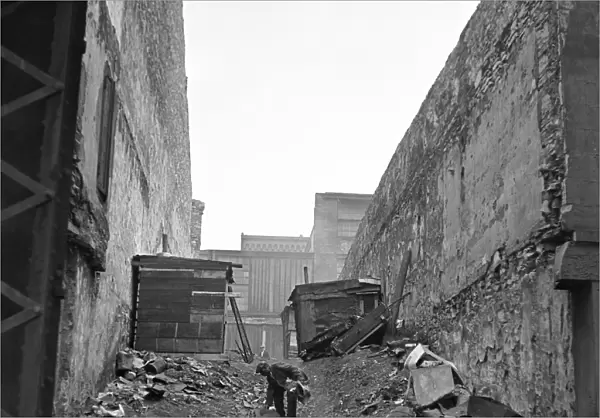 ST. LOUIS: HOBO, 1936. A hobo picking through a mound of trash, St. Louis, Missouri