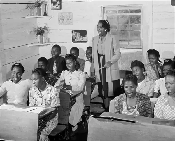 SEGREGATED SCHOOL, 1941. An African American singing class in a rural one room schoolhouse