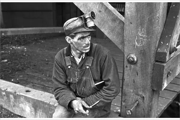 COAL MINER, 1935. Kentucky coal miner taking a smoking break, Jenkins, Kentucky