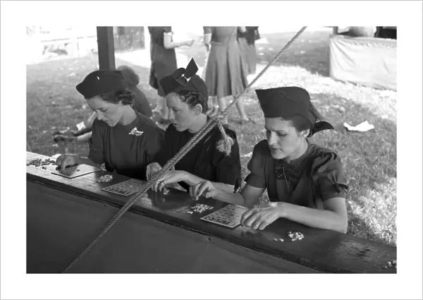 BINGO GAME, 1938. Three women playing bingo at the Louisiana State Fair in Donaldsonville