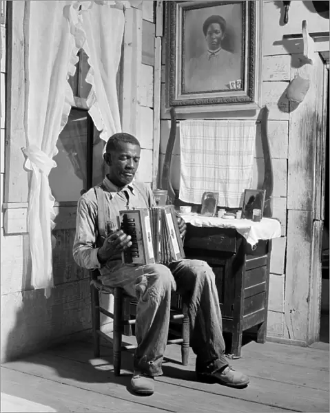 GEORGIA: FARMER, 1941. An African American farmer playing the accordion in his