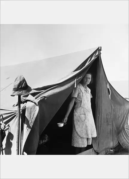 MIGRANT WORKER, 1939. Migrant woman from Arkansas living in a contractors camp near Westley