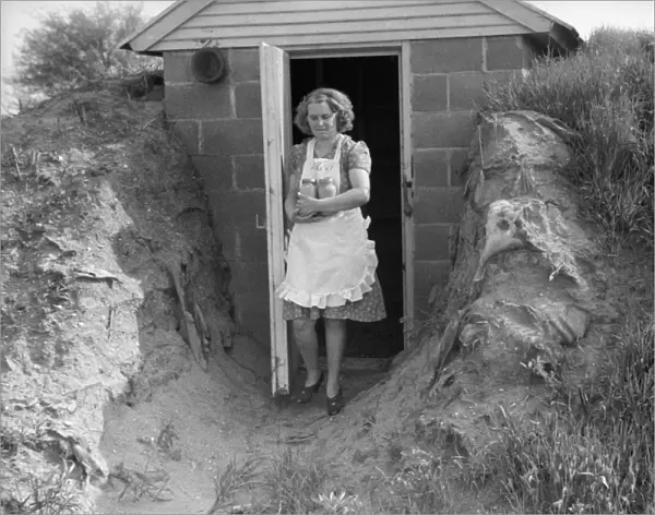 INDIANA: FOOD CELLAR, 1940. A woman retrieving goods from her food storage cellar at Wabash Farms