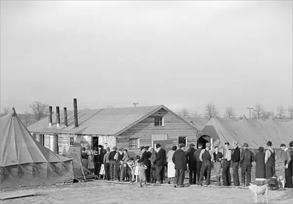 FLOOD REFUGEES, 1937. Flood refugees waiting in a food line at Tent City, near Shawneetown