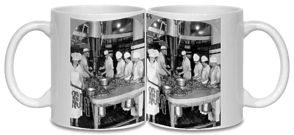 CHICAGO: MEAT PACKING, c1927. Workers making link sausages with machines that stuff