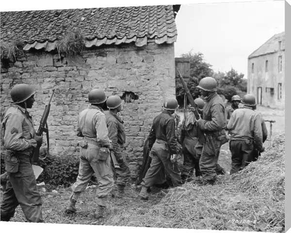 WWII: FRANCE, 1944. American troops preparing to eliminate a German sniper in a