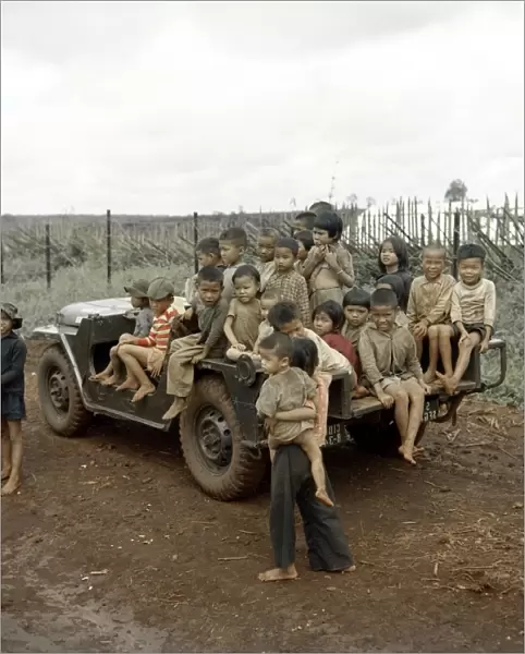 VIETNAM WAR, 1967. Vietnamese children sitting on a US Army Special Forces jeep