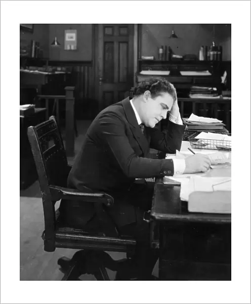 SILENT FILM STILL: OFFICE. American, 1920s