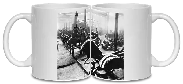 AUTOMOBILE MANUFACTURING. An American auto assembly line, c1910