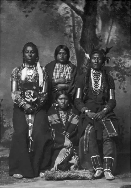 CROW NATIVE AMERICANS, 1883. Four Crow Native Americans. Left to right: Medicine Man, two unidentified women, Old Coyote. Studio photograph by F. Jay Haynes, 1883