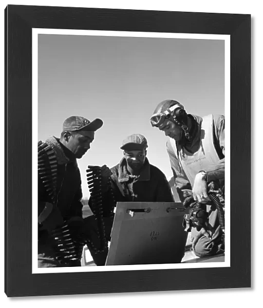 WWII: TUSKEGEE AIRMEN, 1945. Tuskegee Airment Roscoe Brown, Marcellus Smith and Benjamin Davis, with ammunition at Ramitelli Airfield in Italy. Photograph by Toni Frissell, March 1945