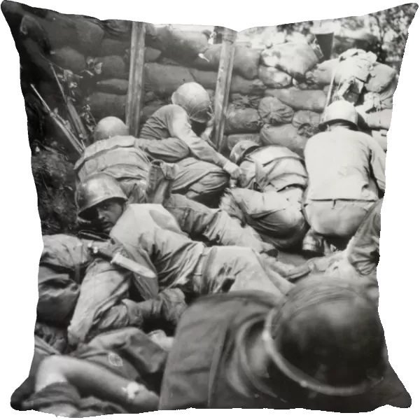 KOREAN WAR, 1950-1953. Infantrymen of the Second U. S. Division take cover from a Communist Chinese mortar barrage in a shallow pit