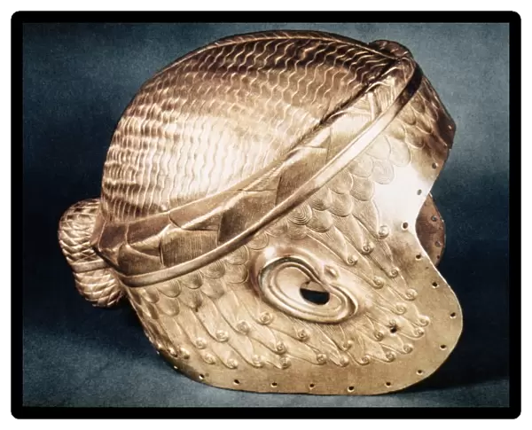 SUMERIAN GOLD HELMET. Gold wig helmet of Meskalam dug from the royal tombs at Ur, c2500 B. C