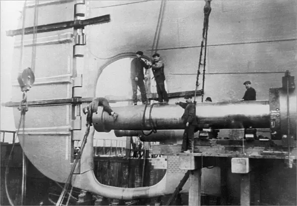 TITANIC: CONSTRUCTION, 1912. Workers assembling the propeller shafts of the RMS Titanic at Harland & Wolff shipyard in Belfast, Ireland. Photograph, c1912