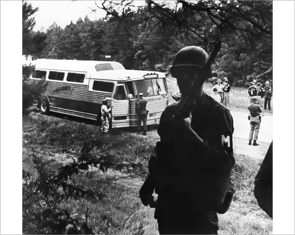 Alabama National Guardsmen and Highway Patrolmen turning over to their Mississippi counterparts the escort duty for a freedom rider interstate bus, 1961