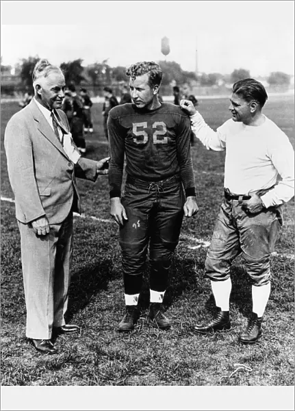 FIELDING YOST (1871-1946). American athletics administrator. Yost (left), as athletic director of the University of Michigan, with football captain Thomas Austin and coach Harry Kipke. Photograph, c1934