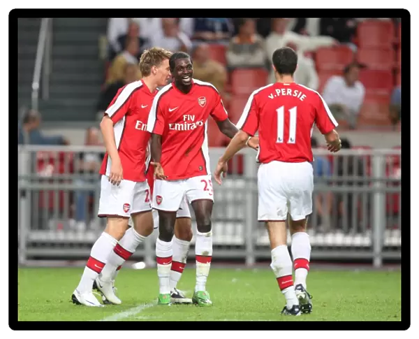 Emmanuel Adebayor and Robin van Persie celebrate Arsenal s