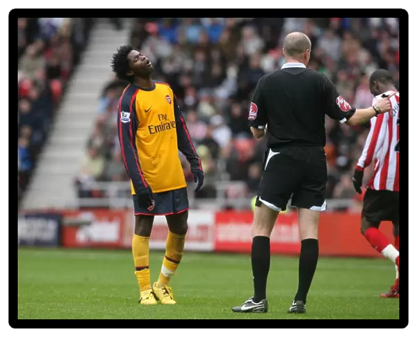 Alex Song (Arsenal) is booked by referee Lee Mason
