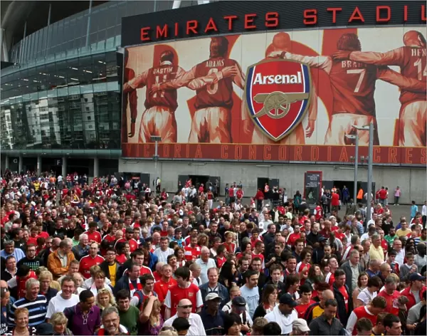 Arsenal fans leave the stadium after the the match
