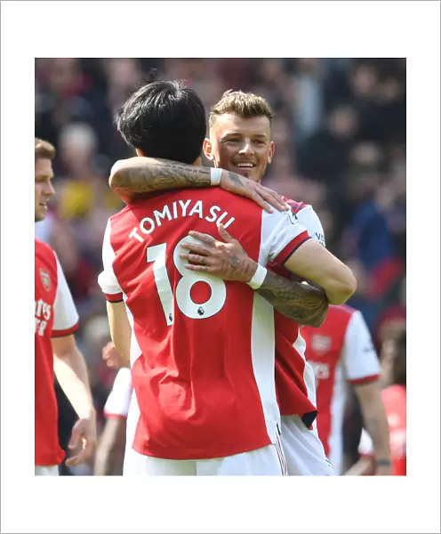 Arsenal's White and Tomiyasu Celebrate Victory Over Manchester United in Premier League