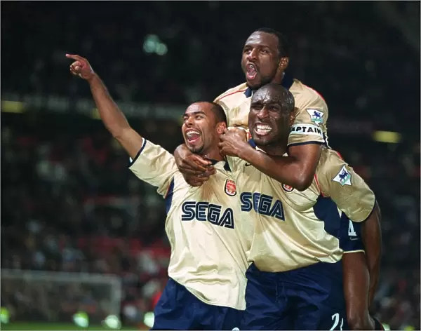 Triumphant Threesome: Arsenal's Vieira, Cole, and Campbell Celebrate Championship Victory over Manchester United