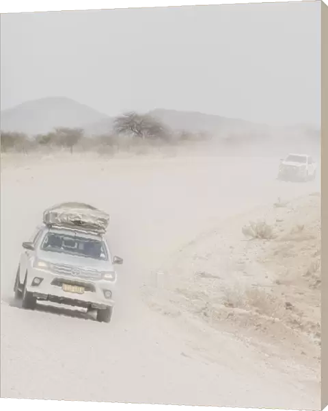 Cars on a dusty desert road in Namibia