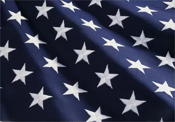These are the stars of the American flag. They are against their blue field, climbing upward toward the corner of the image as if they were situated on small stairs that move up in levels
