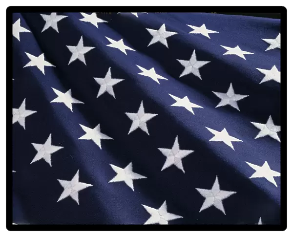 These are the stars of the American flag. They are against their blue field, climbing upward toward the corner of the image as if they were situated on small stairs that move up in levels
