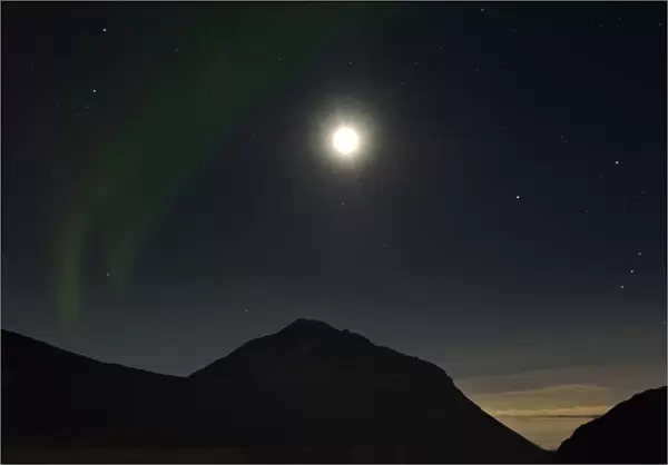 A glimpse of Northern Lights on a winter night in Iceland, with moon 4