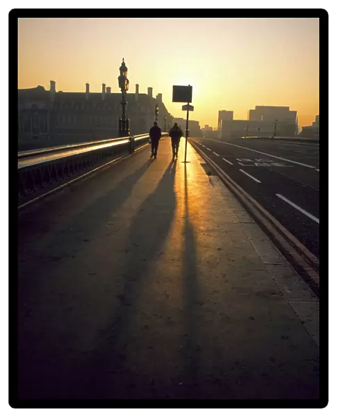 Two people on Westminster Bridge at sunrise